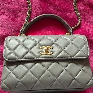 Gray quilted crossbody top handle purse with gold hardware.